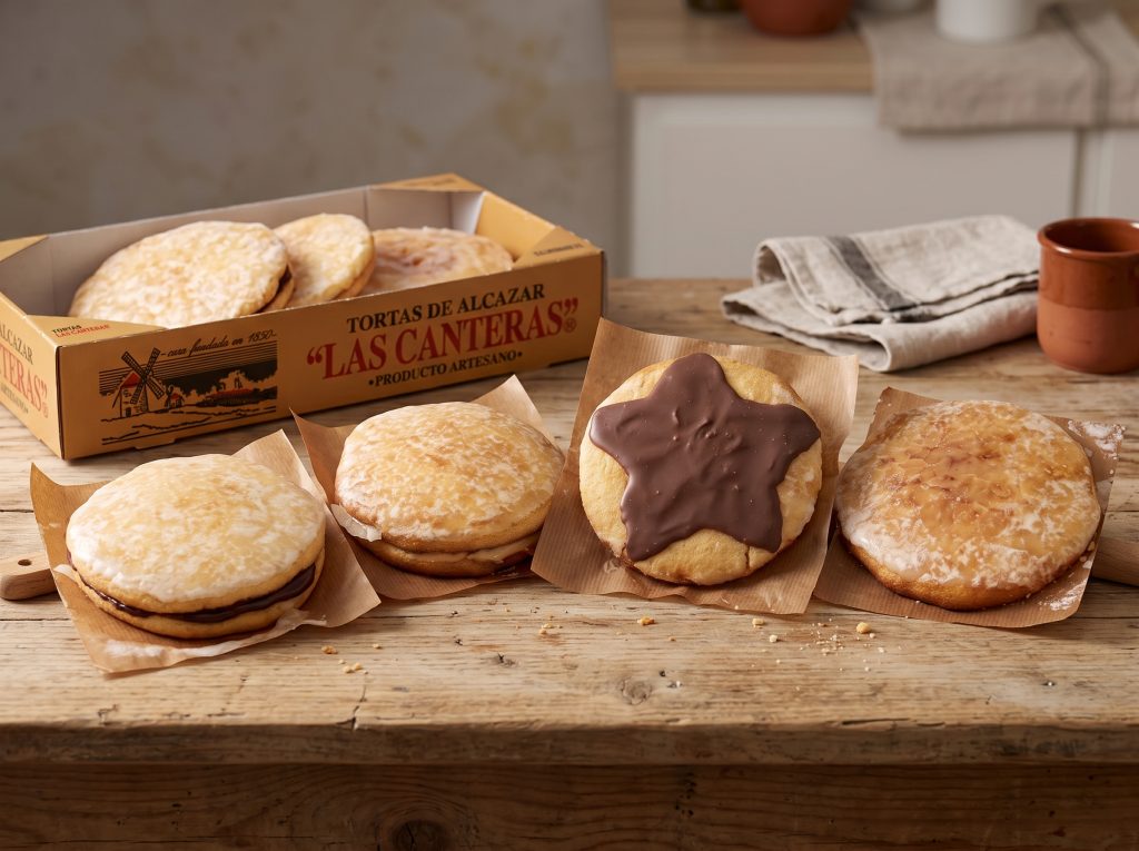 Pack Degustación de tortas de Alcázar Las Canteras: estuche y distintas variedades de torta sobre una mesa de madera